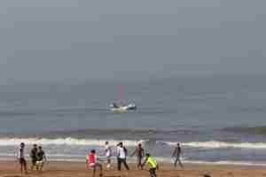 Beach, ball, boys and boat :)